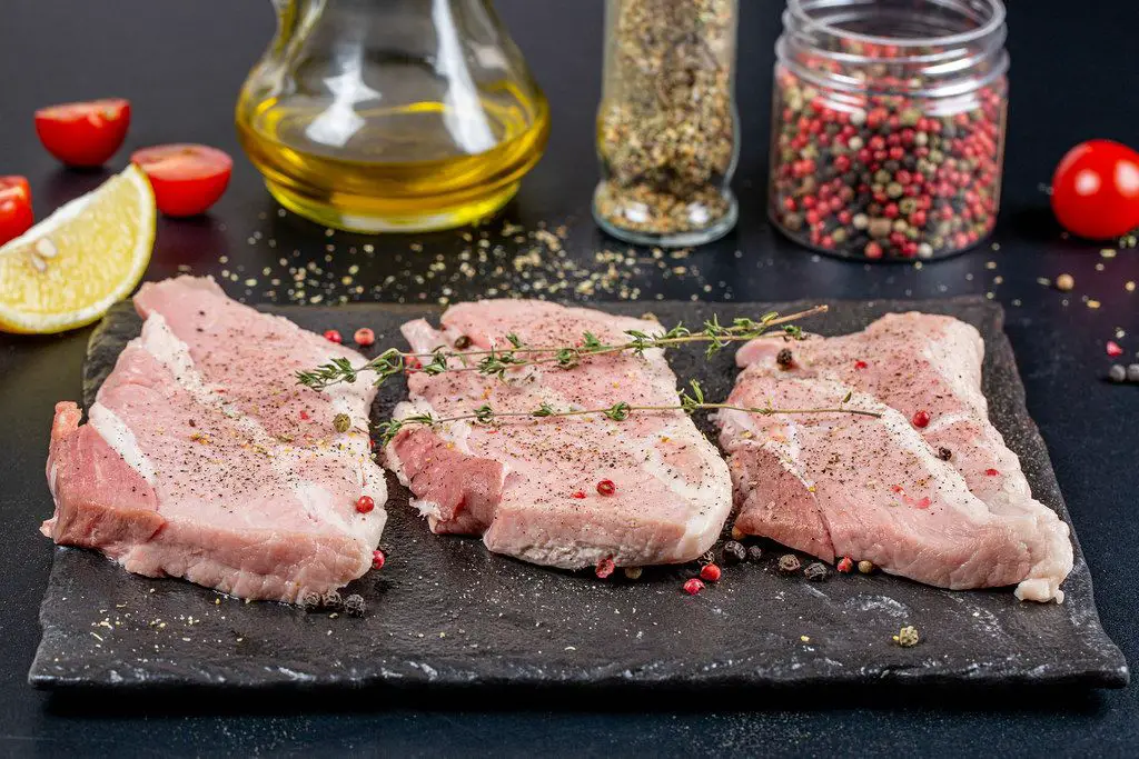 An assortment of premium steaks and pork chops.